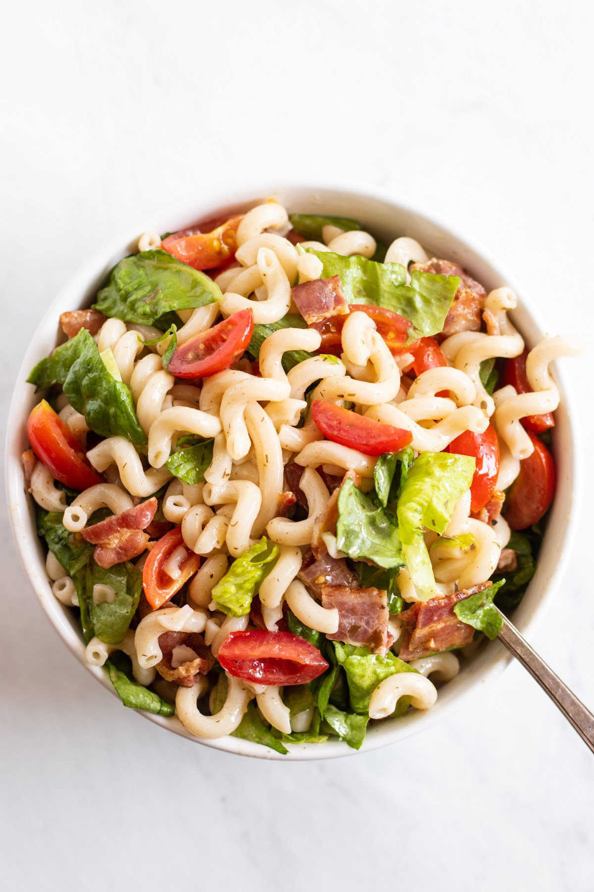 Looking into a bowl of low FODMAP BLT Pasta Salad. 