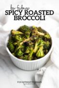 Roasted broccoli in a small white bowl. In the white space above, black text reads "low FODMAP spicy roasted broccoli".