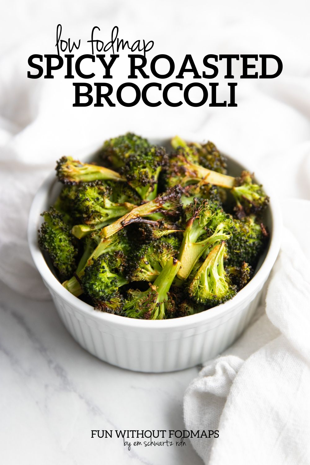 A small bowl of roasted broccoli. In the white space above, black text reads "Low FODMAP Spicy Roasted Broccoli".
