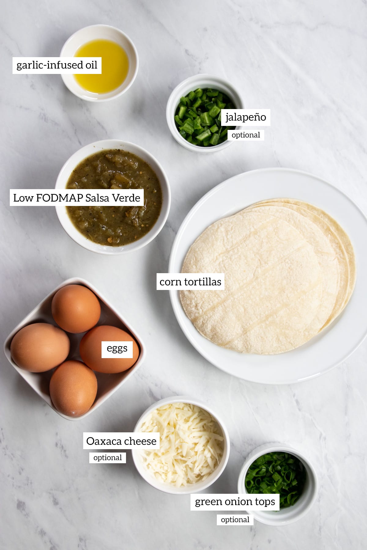Ingredients needed for Low FODMAP Salsa Verde Eggs are prepared and measured into individual dishes.