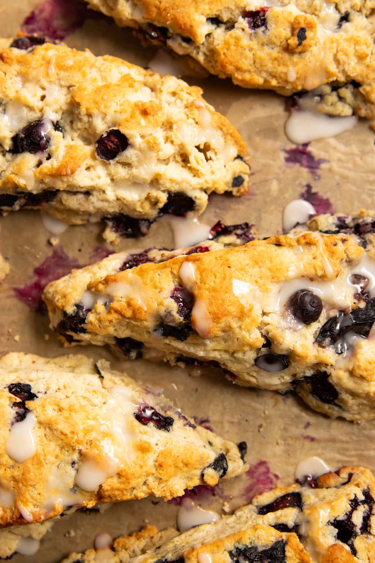 Looking down at a baking sheet filled with five low FODMAP blueberry scones