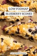 Five blueberry scones on a baking sheet lined with brown parchment paper. Black text in a white box reads "Low FODMAP Blueberry Scones" and "FUN WITHOUT FODMAPS."