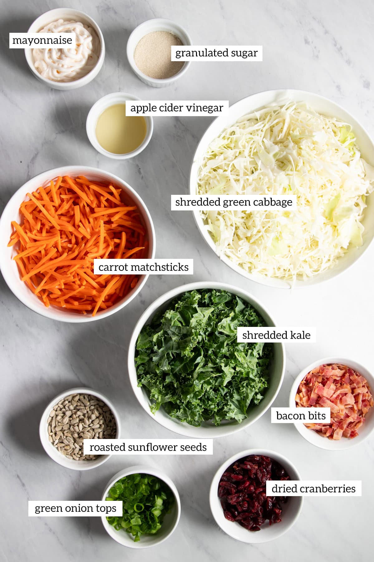 The ingredients needed for low FODMAP sunflower crunch salad are prepared and measured out into individual dishes.