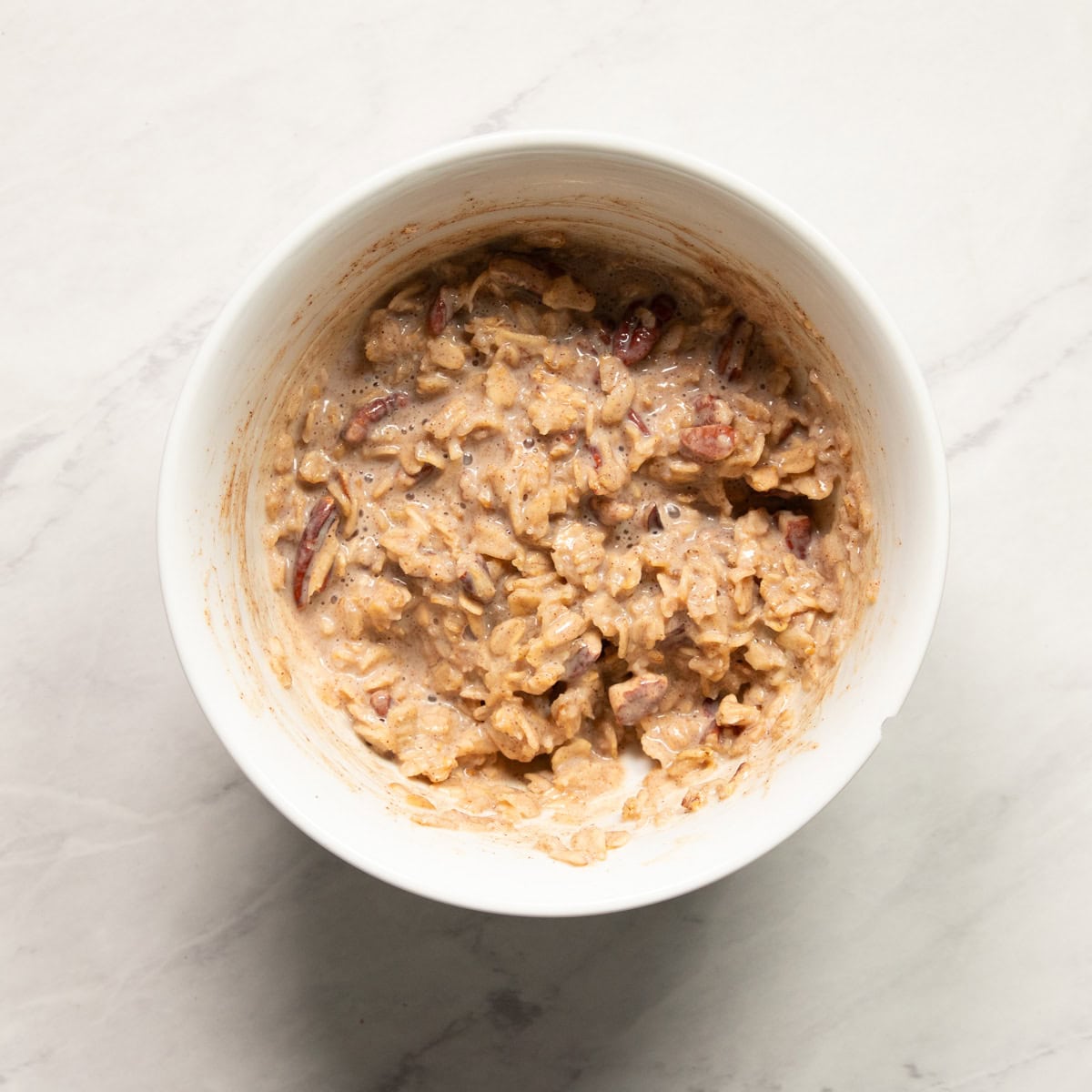 A bowl of cooked oatmeal made with lactose-free milk