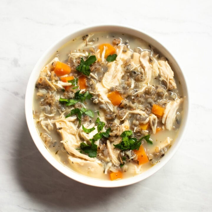 A close up of a bowl of chicken wild rice soup made with FODMAP-friendly ingredients.