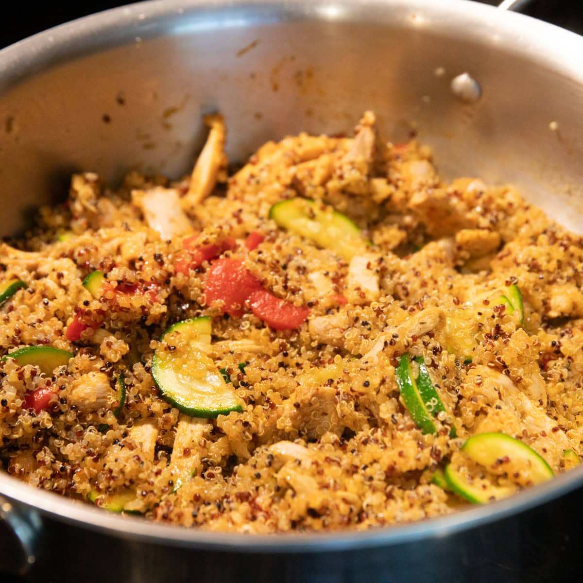 Cooked quinoa is added to the Cajun chicken and veggies.