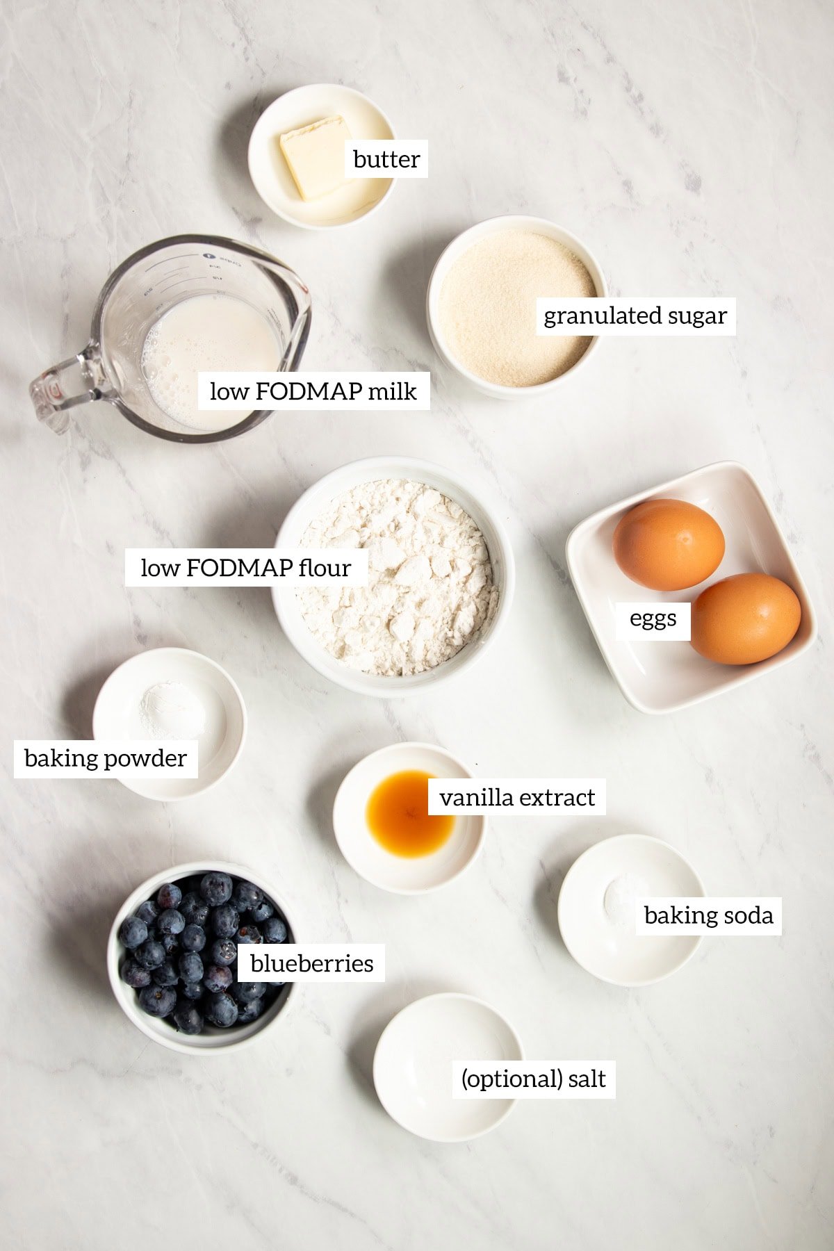 Ingredients needed for these low FODMAP waffles are prepared and measured out into individual dishes ready for cooking.