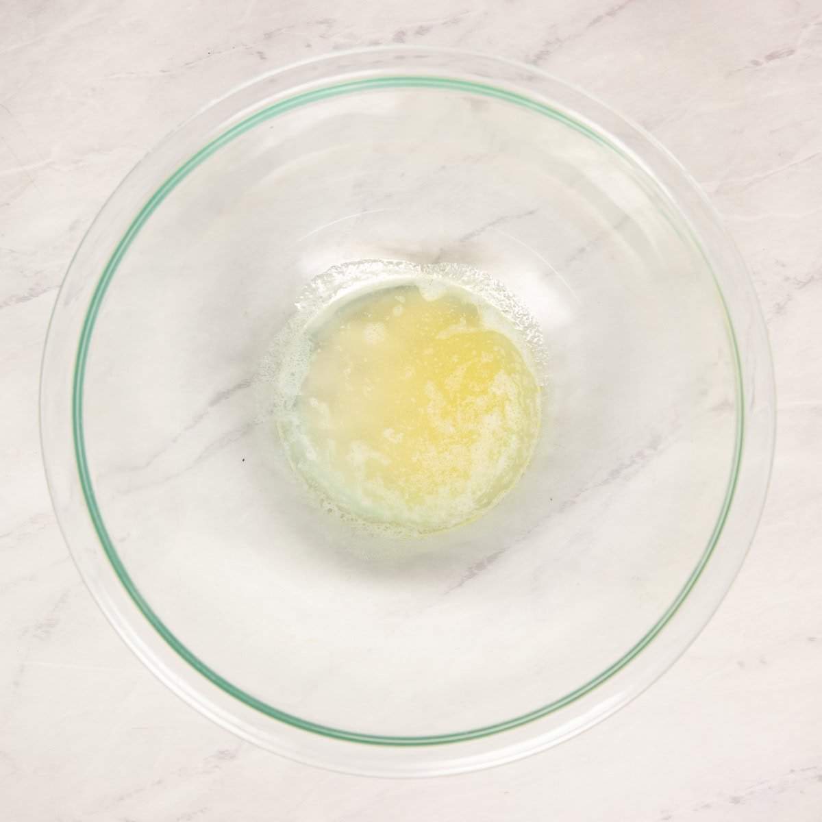 Melted butter in a large mixing bowl.