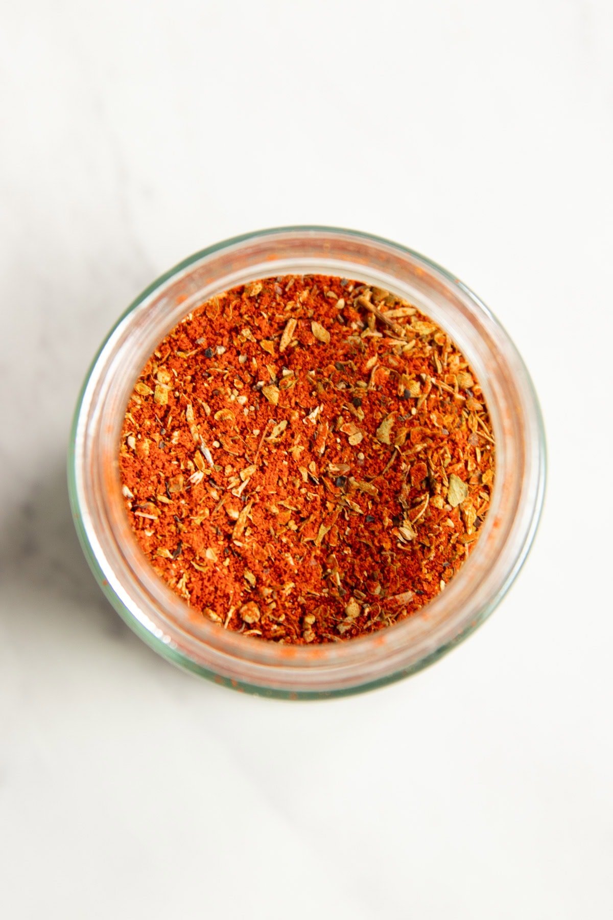Looking down into a mason jar filled with a paprika-based spice blend.