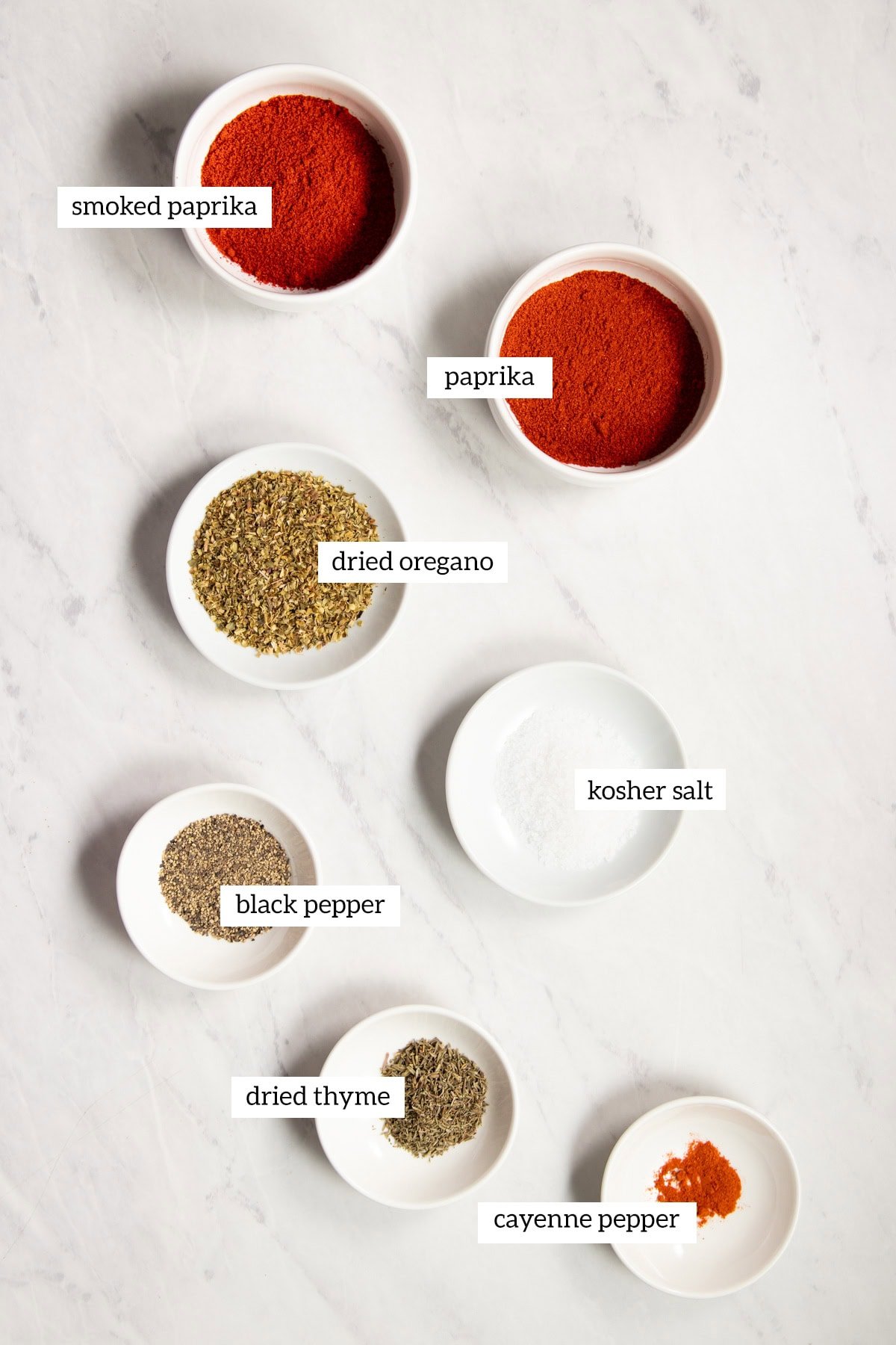 The ingredients needed for low FODMAP Cajun seasoning are measured out into individual dishes ready to prepare.