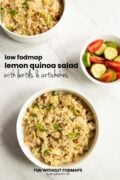 Three bowls are staggered on a white marble counter. In the white space, black text reads "Low FODMAP Lemon Quinoa Salad with Lentils and Artichokes."