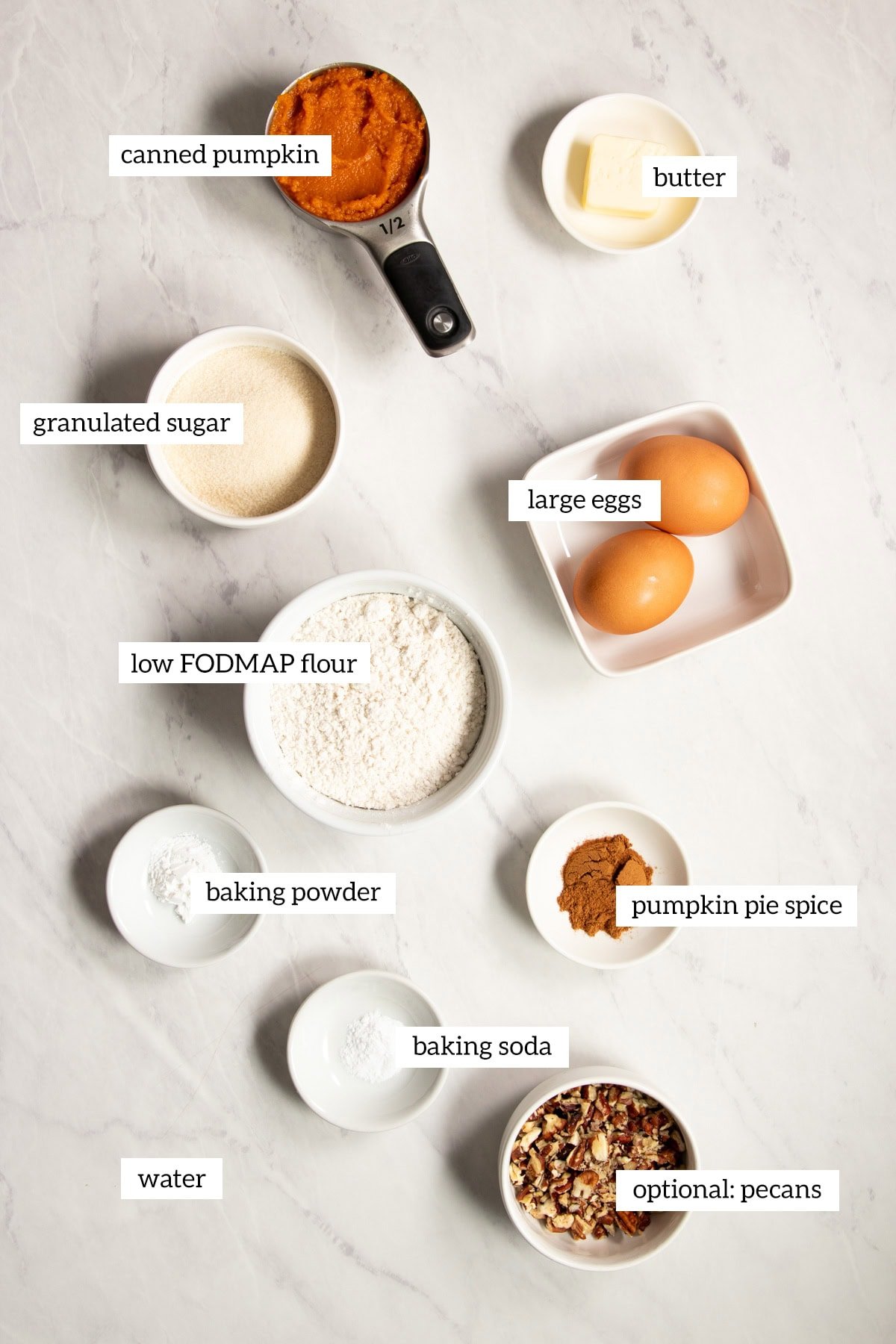 Ingredients needed for low FODMAP pumpkin spice waffles are prepared and measured out into individual dishes ready for cooking.