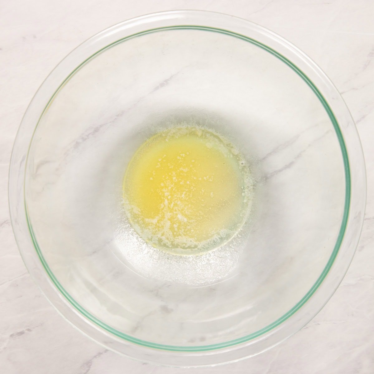 Butter melted in a large glass bowl. 
