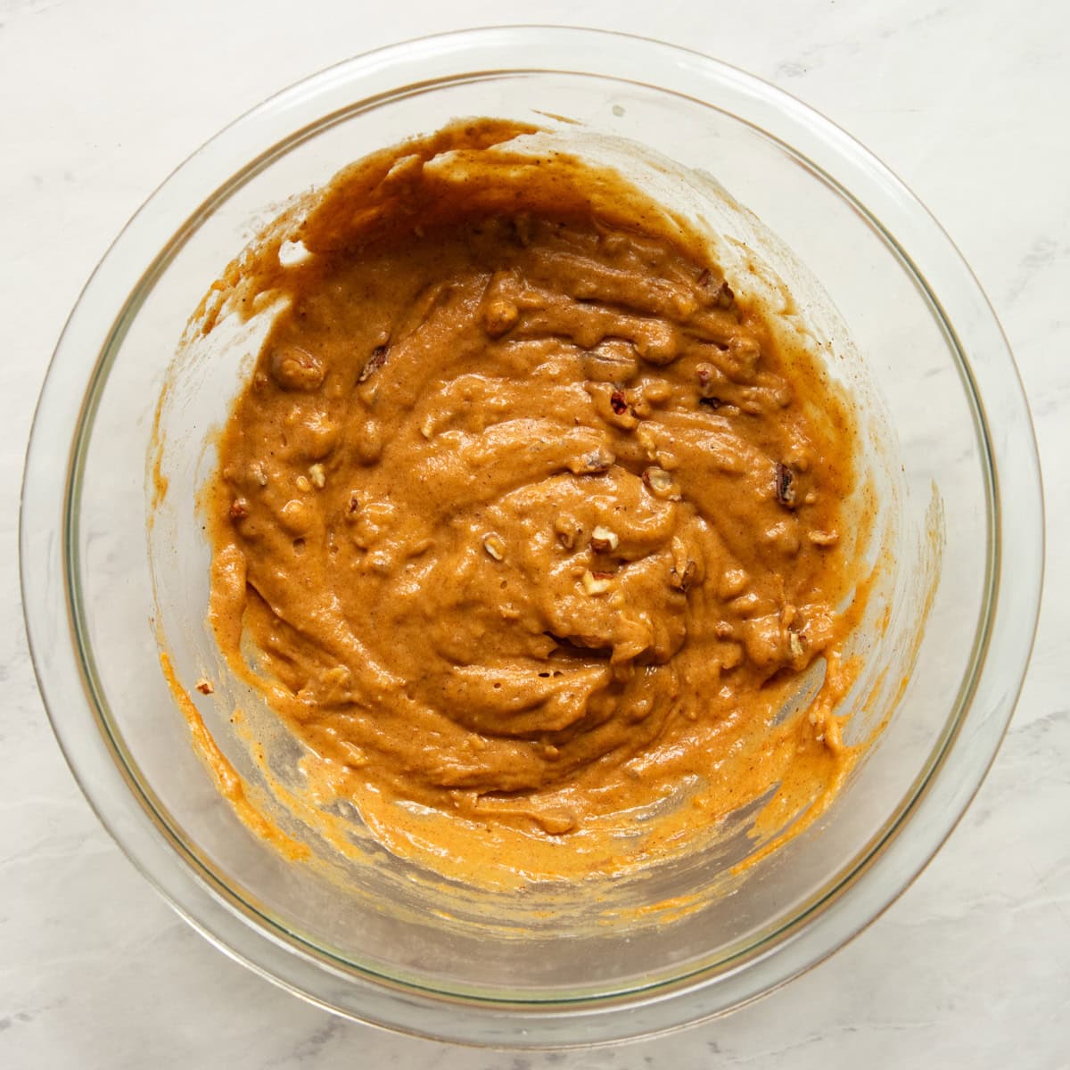 Optional chopped pecans have been folded into the low FODMAP pumpkin spice waffle batter.