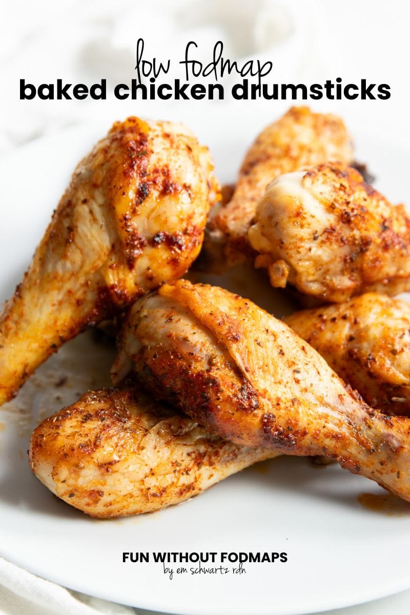 A plate of baked chicken. In the white space above, black text reads "Low FODMAP Baked Chicken Drumsticks."