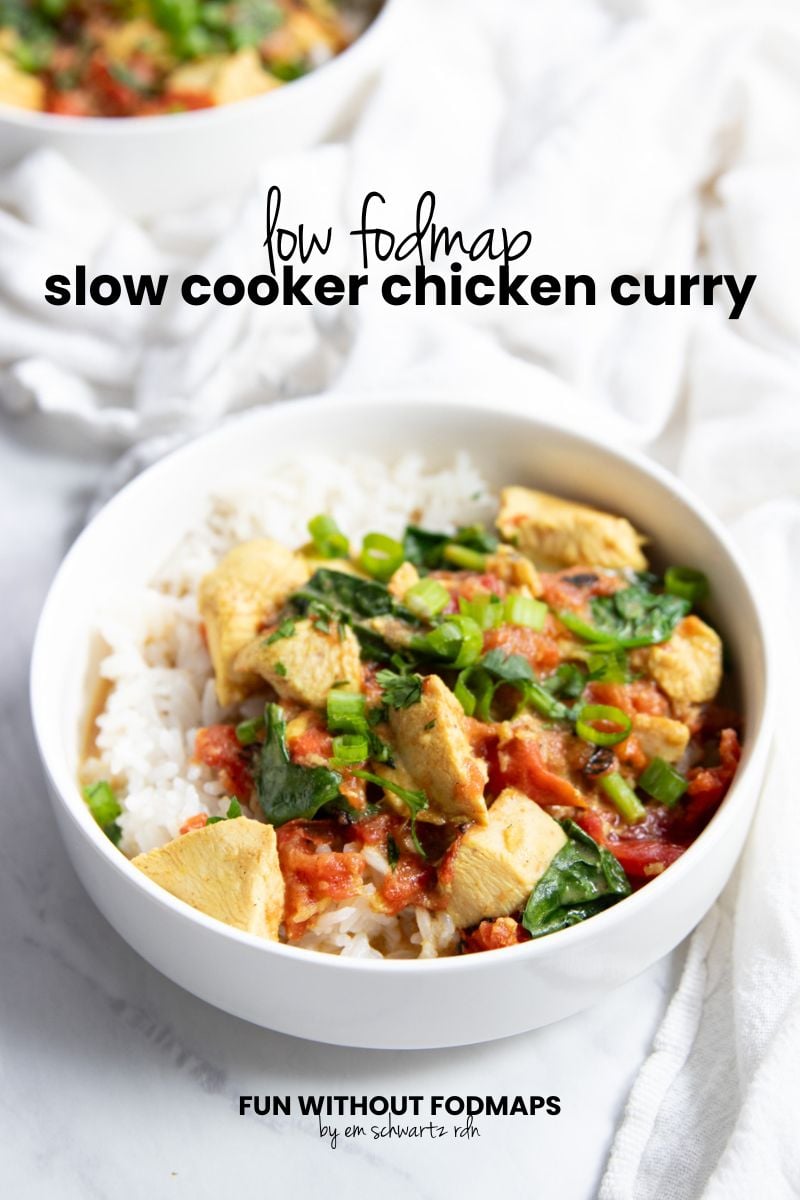 A bowl of chicken curry over rice sits on a white counter surrounded by a white linen napkin. A second bowl peeks into the upper left corner. In the white space, black text reads "Low FODMAP Slow Cooker Chicken Curry."
