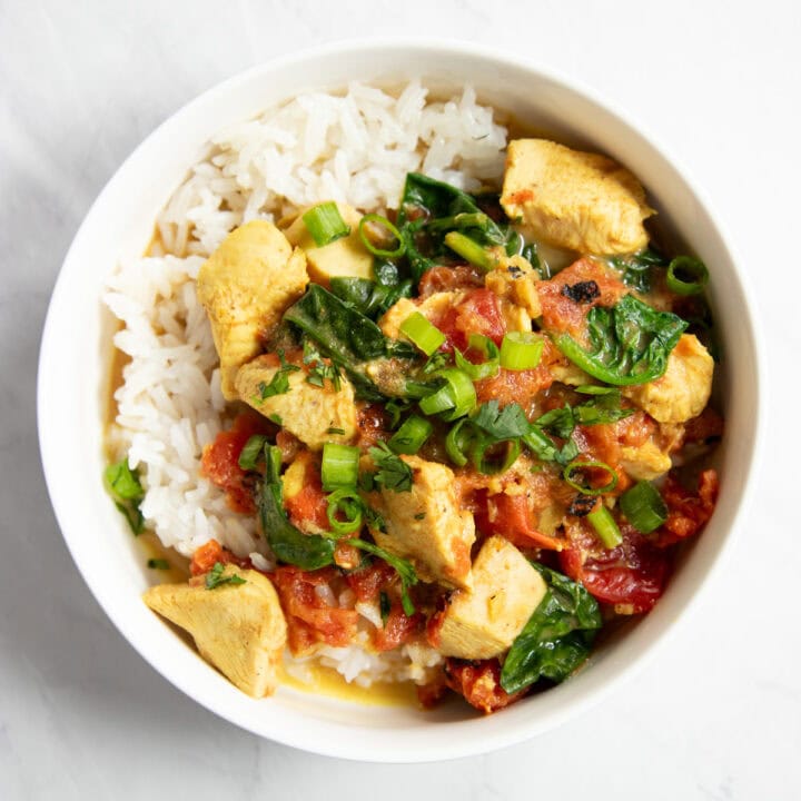 A bowl of low FODMAP slow cooker chicken curry over white rice.