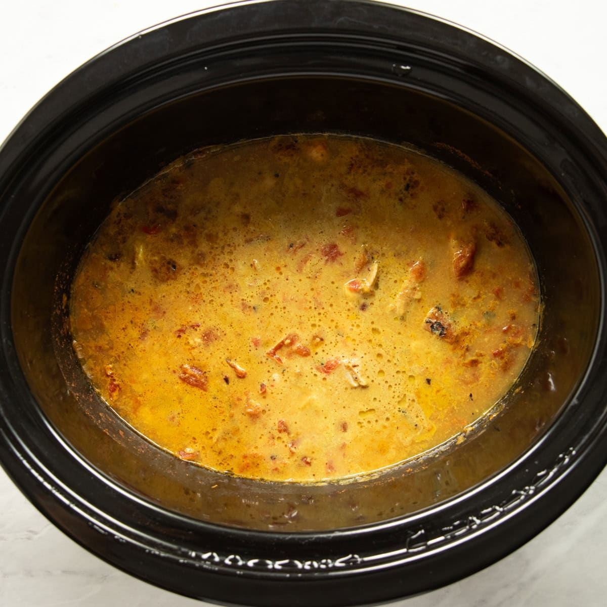 The slow cooker chicken curry is cooked in the slow cooker.