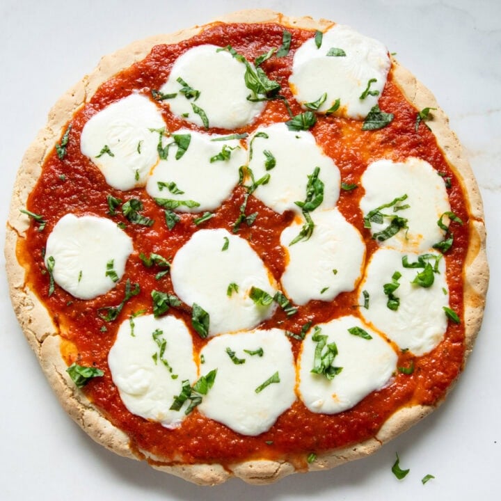 Looking down at a full homemade cheese pizza.
