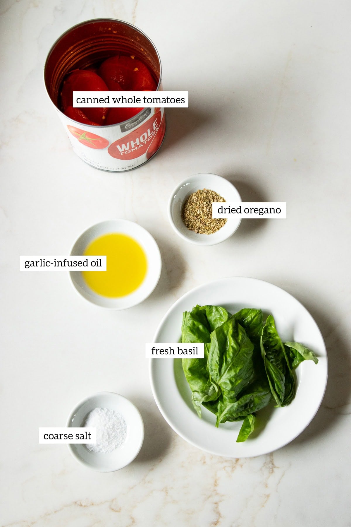 Ingredients needed for low FODMAP pizza sauce are measured out into individual dishes. There is a text overlay label over each ingredient.