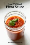 A glass jar of tomato sauce sits on a white counter. In the surrounding space, a black text overlay reads Low FODMAP Pizza Sauce.