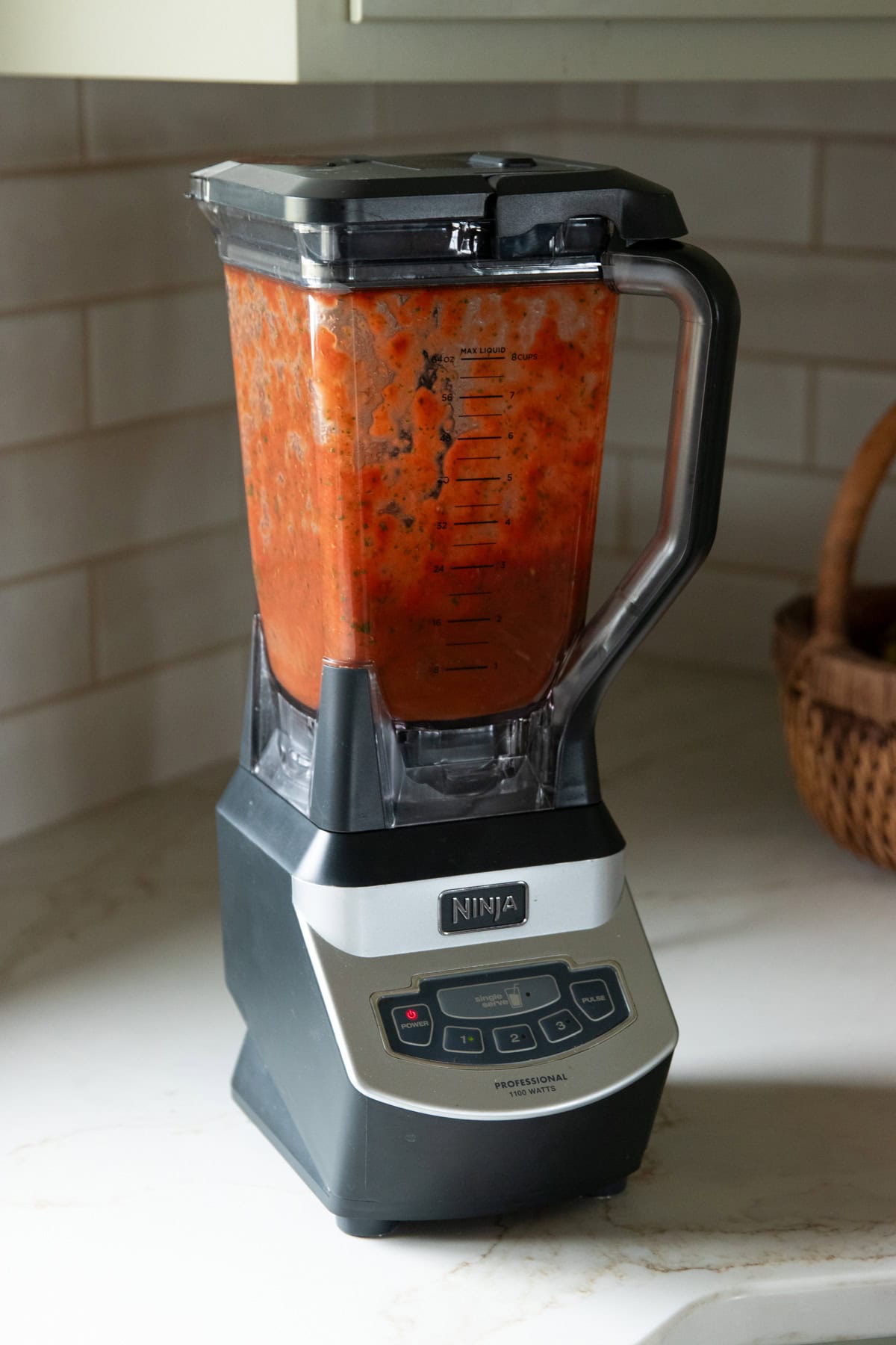 Blending pizza sauce in a Ninja blender.