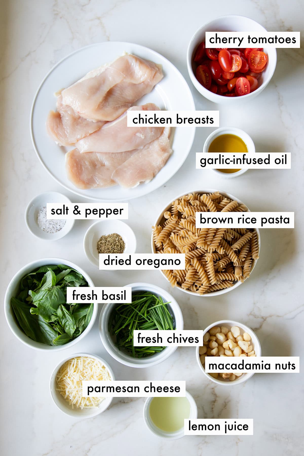 Ingredients needed for Low FODMAP Pesto Pasta with Chicken are prepared and measured out into individual containers ready for cooking.