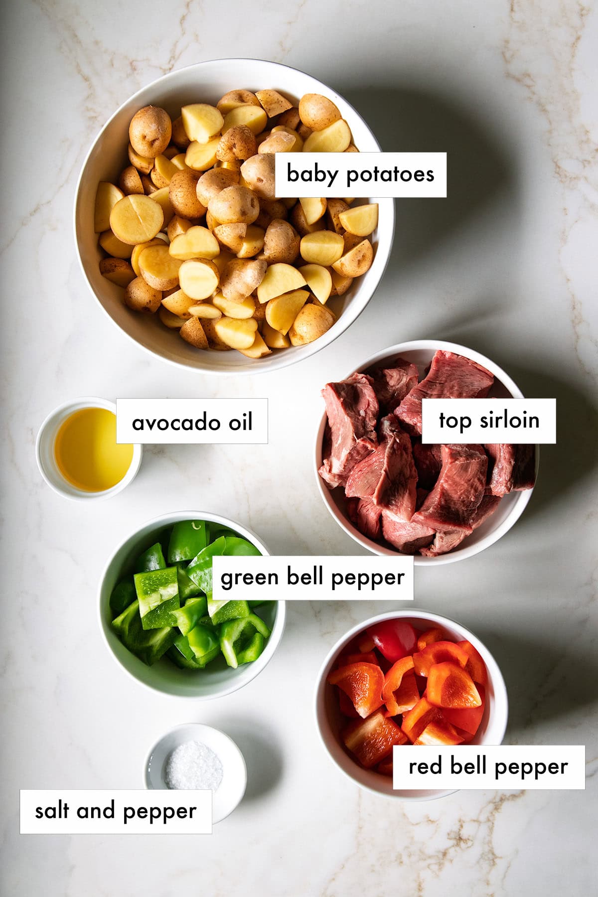 Ingredients needed for Low FODMAP Steak and Potatoes Sheet Pan Meal are prepped and measured out into individual containers.