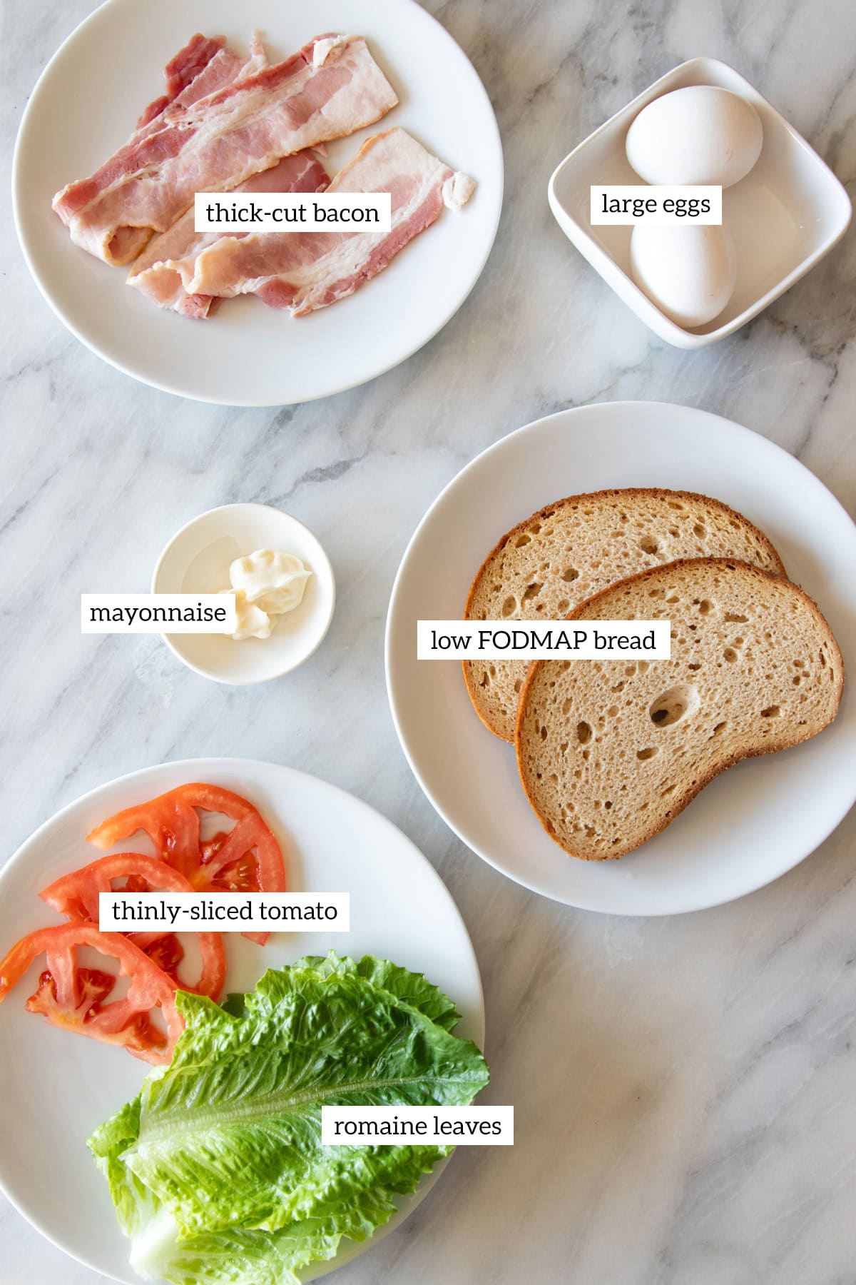 Ingredients needed to make Low FODMAP BLTs with Egg are prepared and measured out into individual dishes ready for cooking.